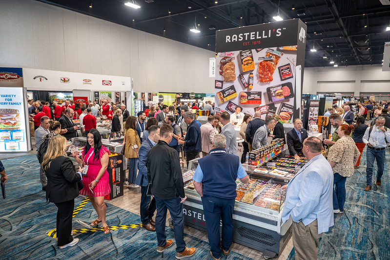 Patrons mingling at exhibits at Annual Meat Conference