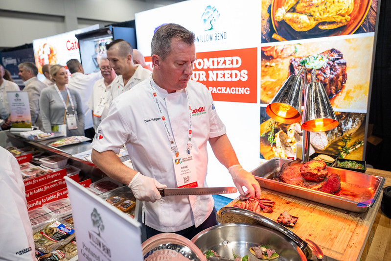 Man chopping brisket at Annual Meat Conference