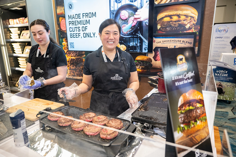 Exhibitor showing cooked meat at Annual Meat conference