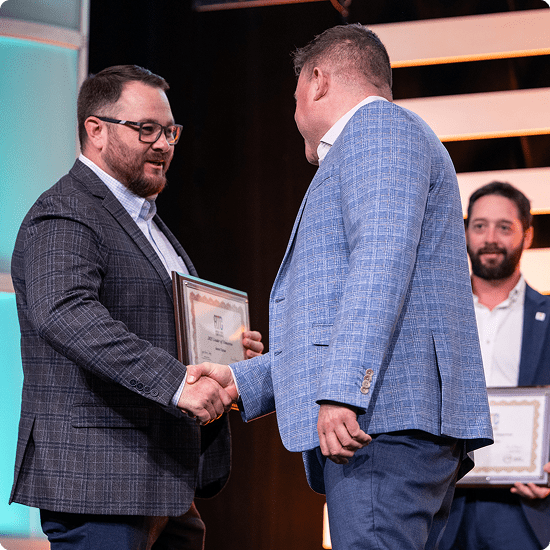 Two men shaking hands at conference